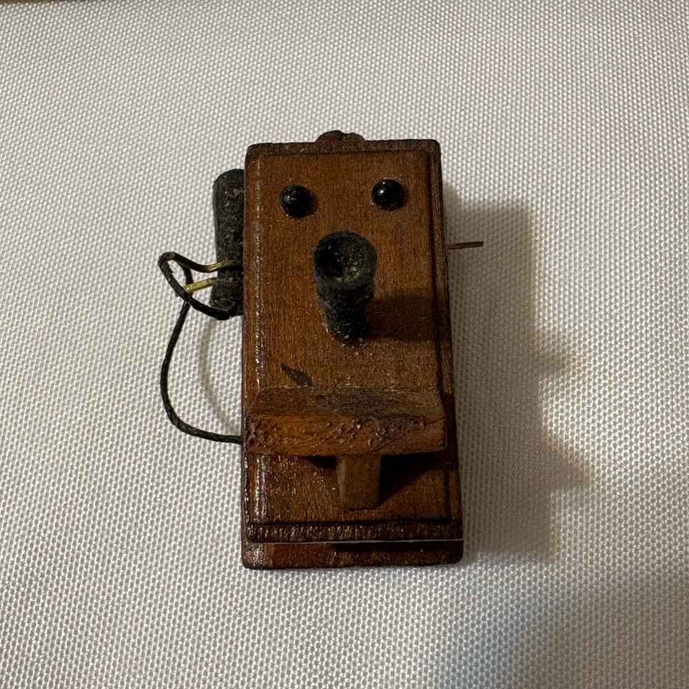 Vintage miniature dollhouse wall-mounted telephone replicates old fashioned 1890